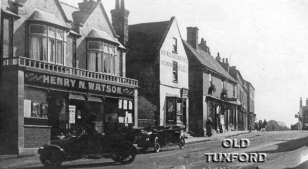 Looking up Eldon Street, cars outside Watson's motor and cycle dealers