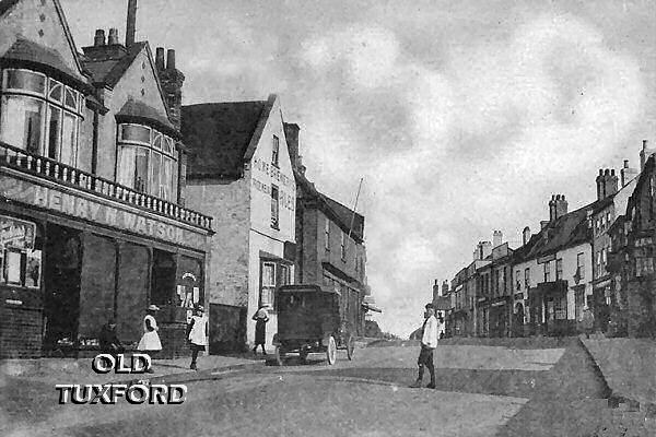 Looking up Eldon Street, old car, children playing