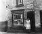 Mrs Newton outside her newsagents shop on Lincoln Road, now Halls