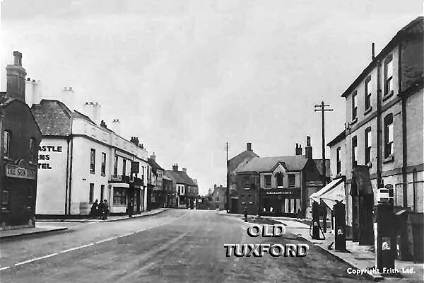 Petrol pumps outside Sanderson's Garage, newly dug ground in the Market Place